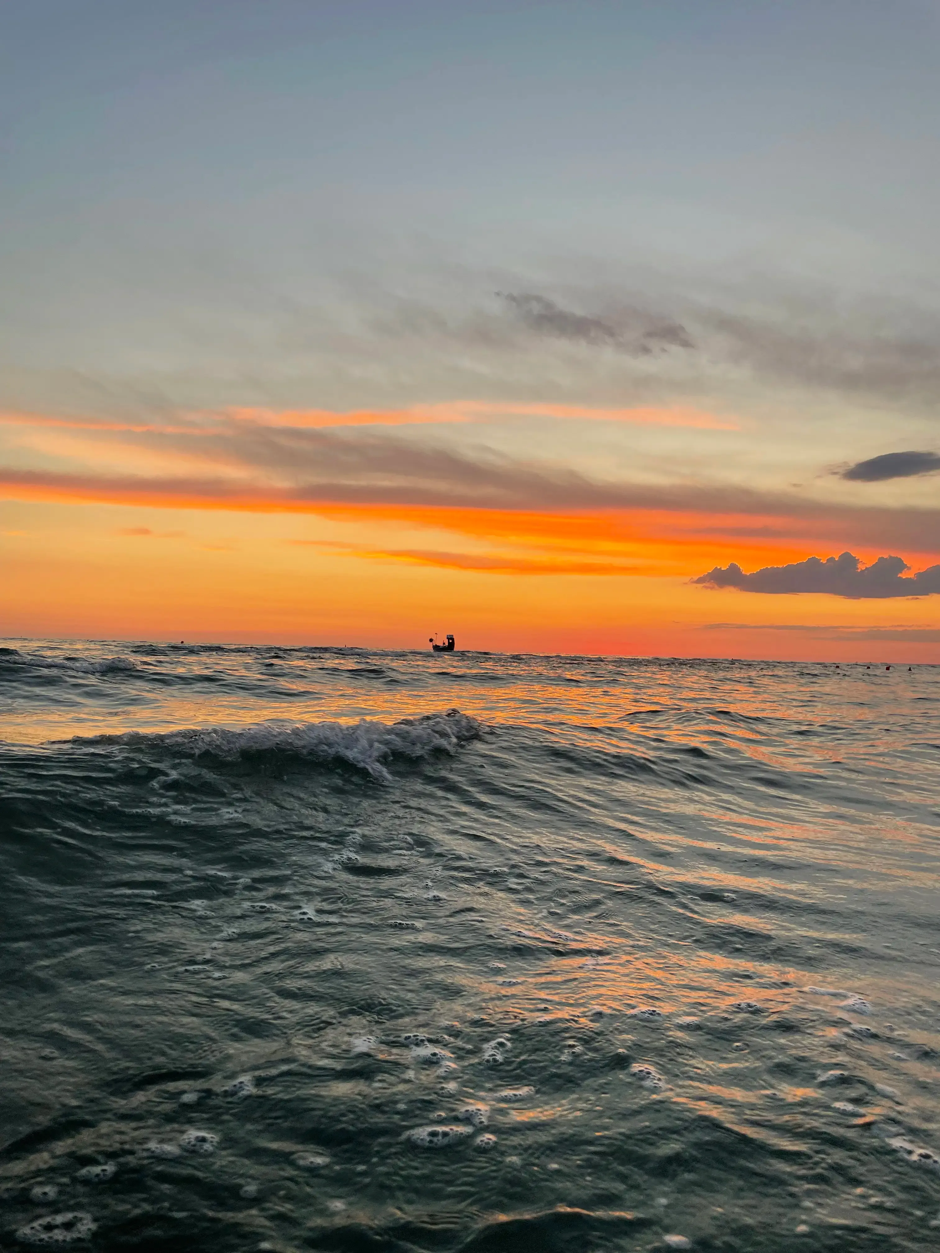 Santorini-style white architecture and sea view at sunset